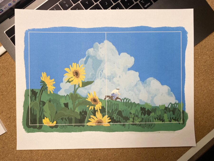 Printed paper with illustration of man biking through sunflower trail under blue skies